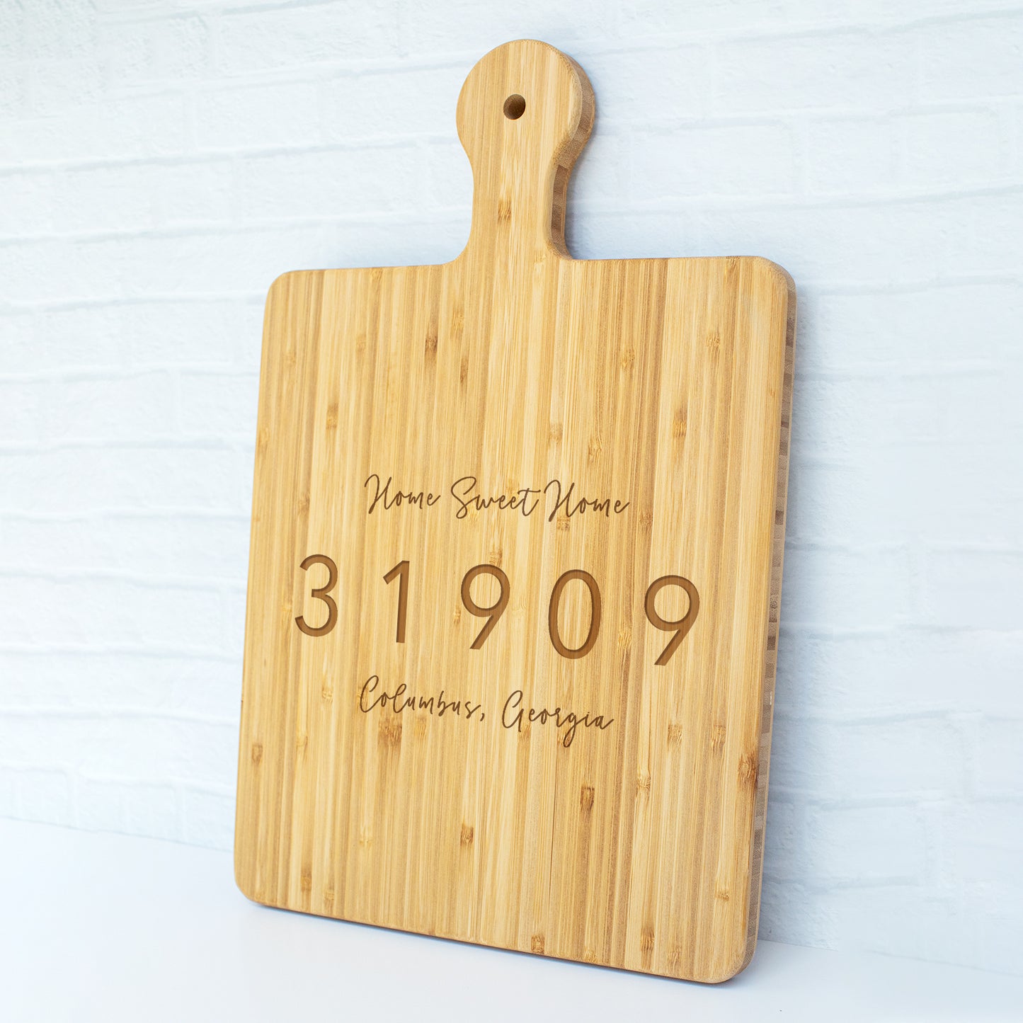 a cutting board with a name and date engraved on it
