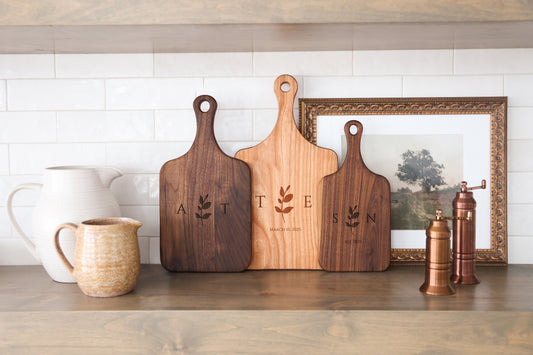 a couple of wooden cutting boards sitting on top of a counter