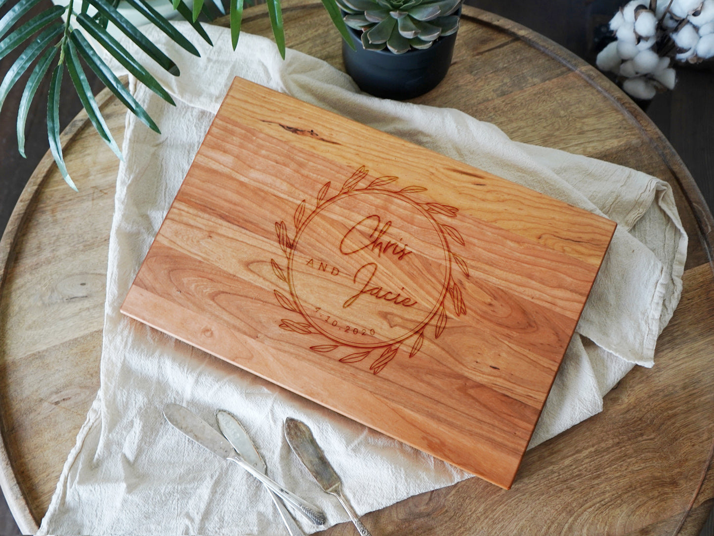 a cutting board on a table with a plant in the background