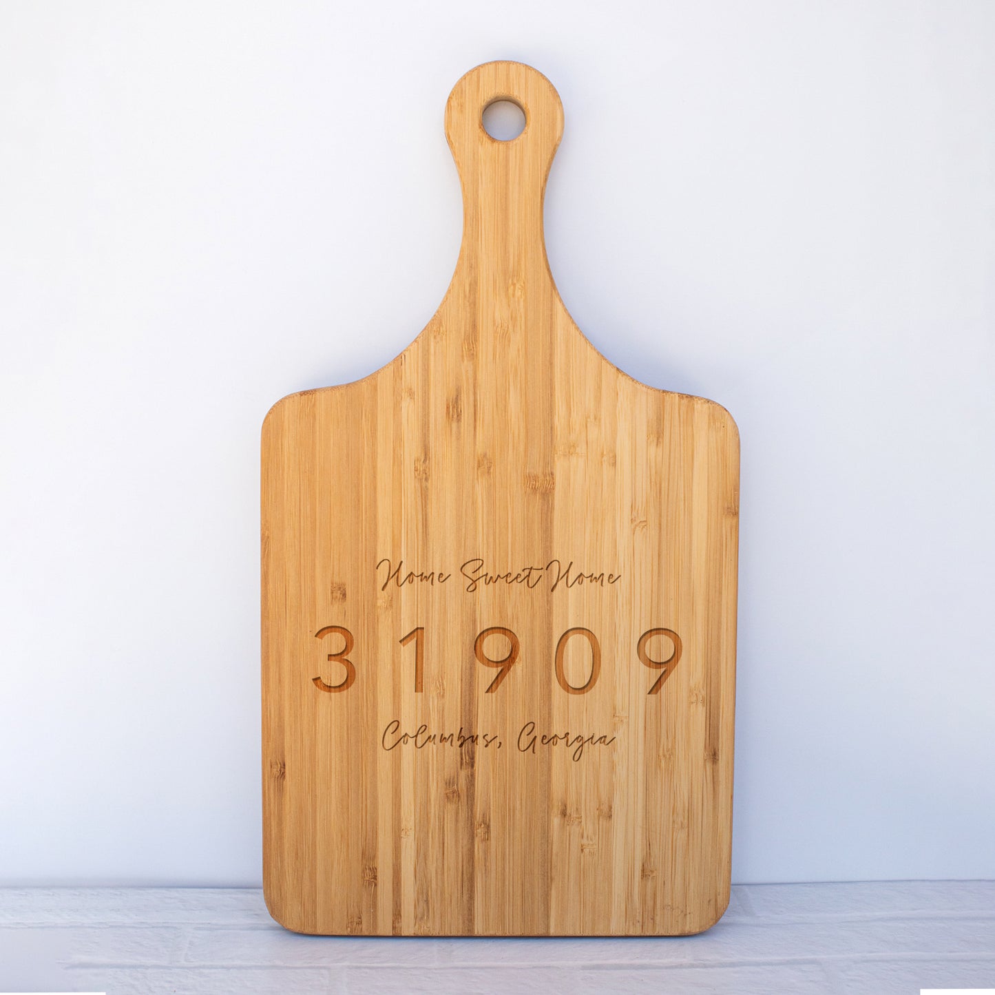 a wooden cutting board with a date engraved on it
