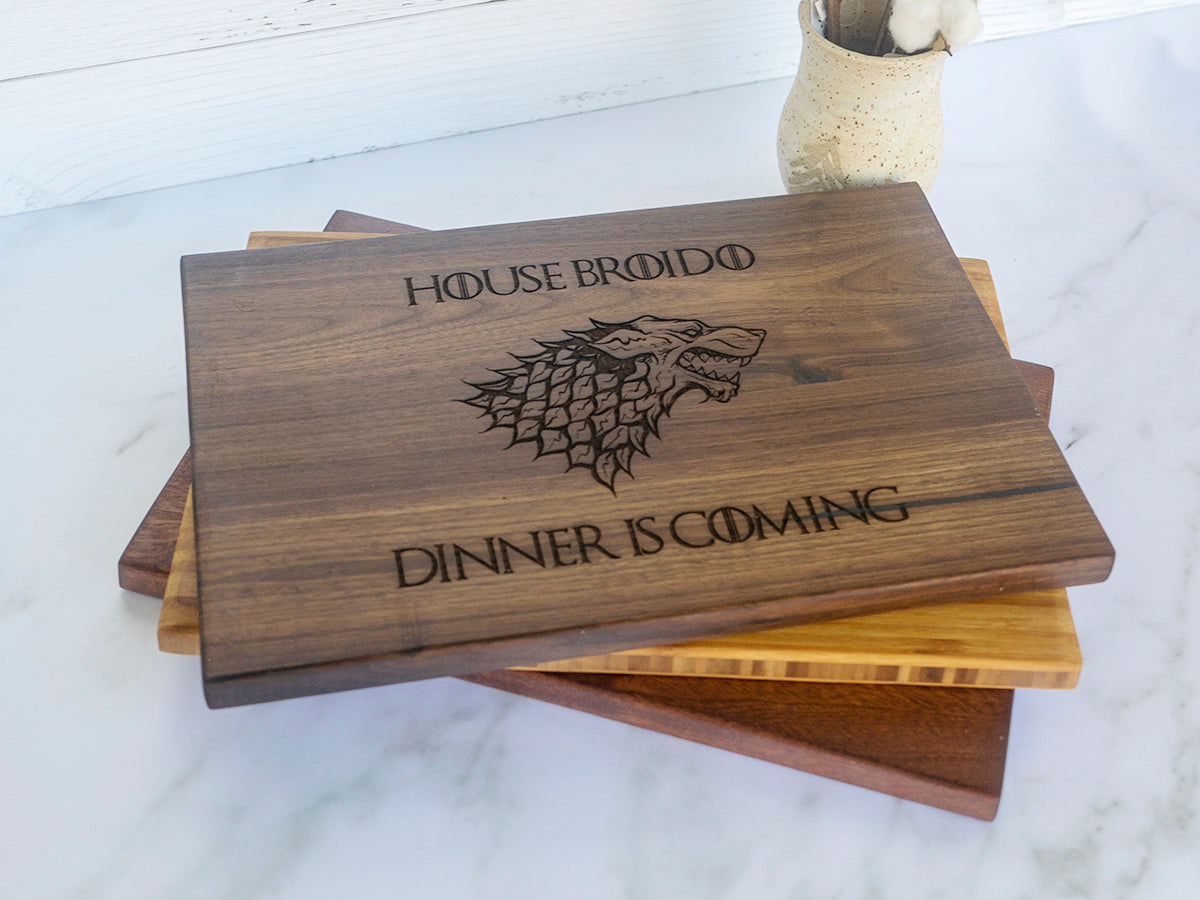 a wooden coaster with a game of throne logo on it