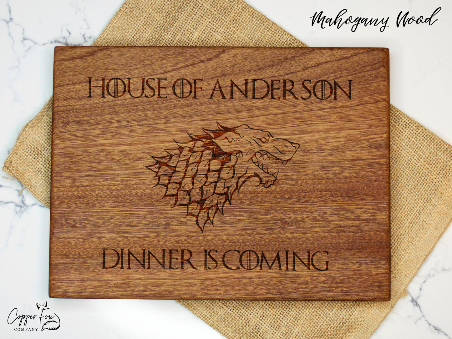 a wooden coaster with a game of throne logo on it