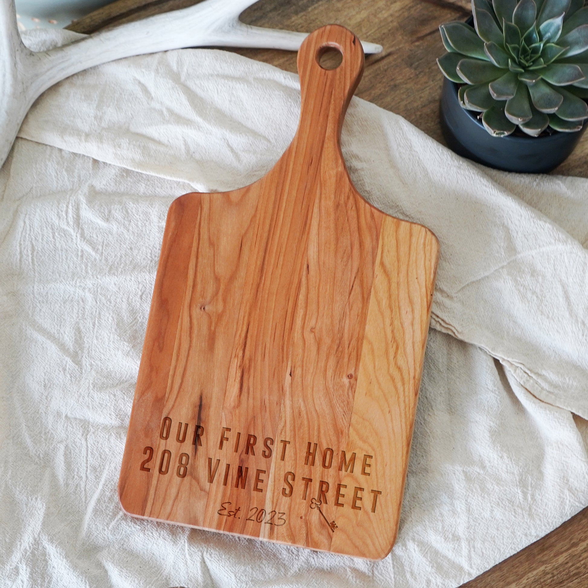 a wooden cutting board sitting on top of a table