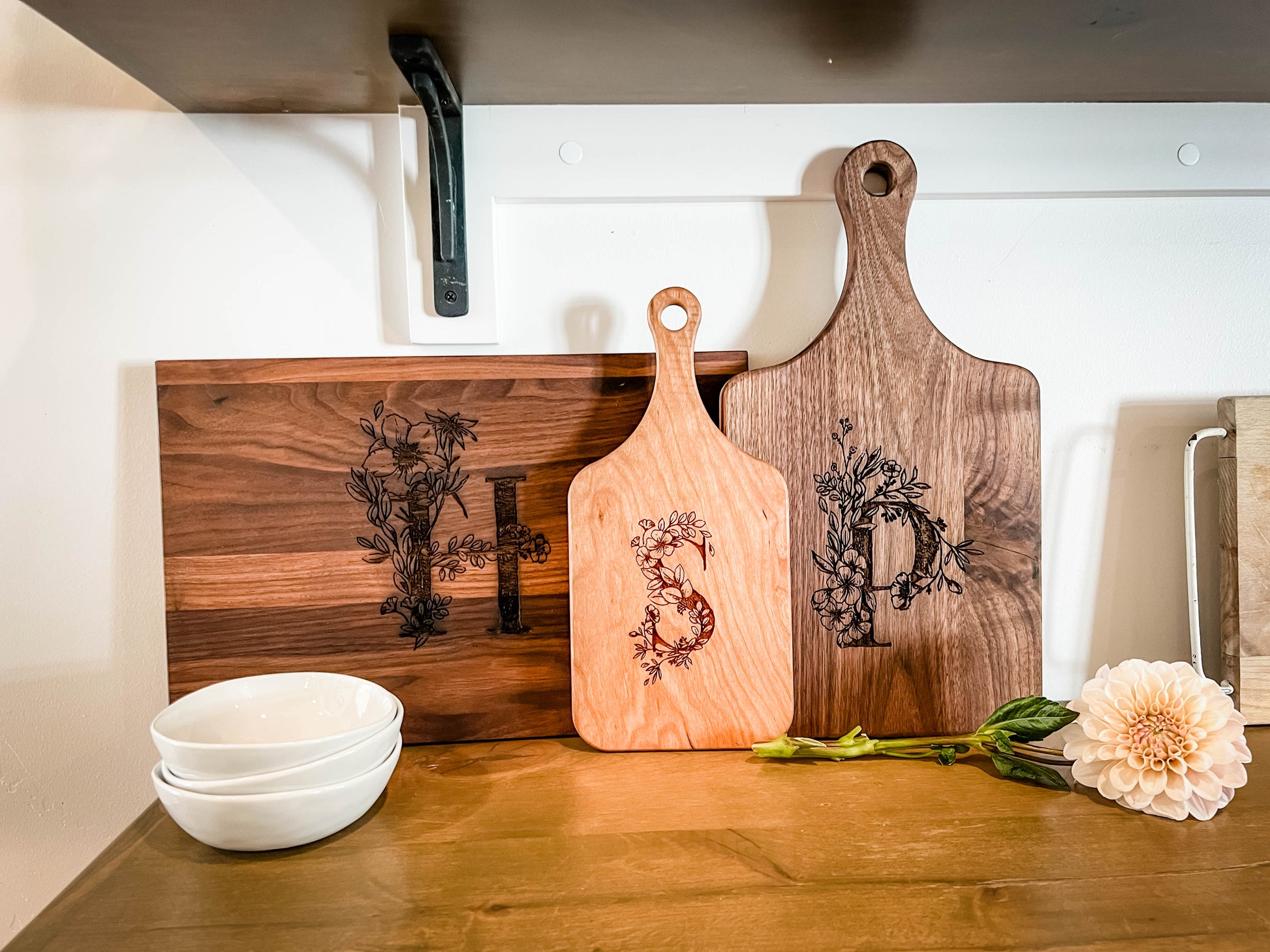 a couple of cutting boards sitting on top of a wooden counter
