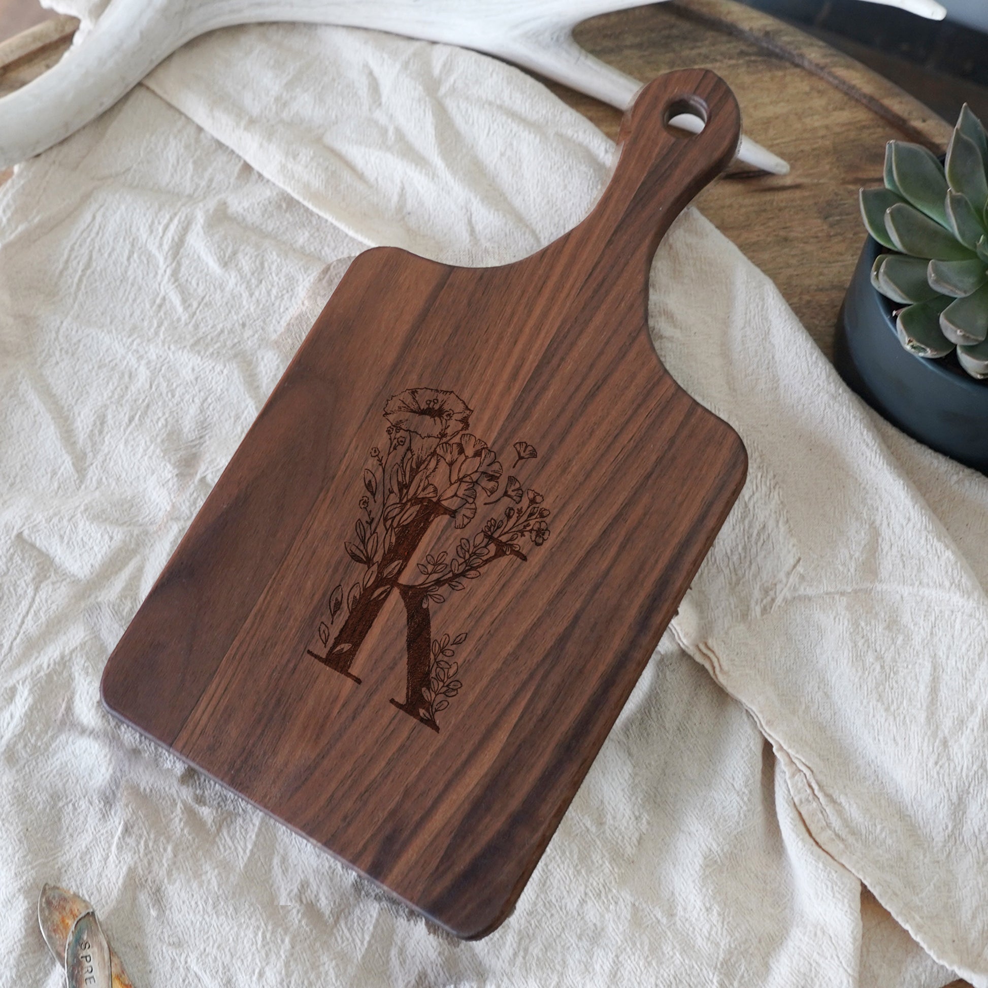 a wooden cutting board sitting on top of a table