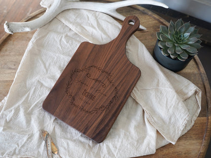 a wooden cutting board sitting on top of a table