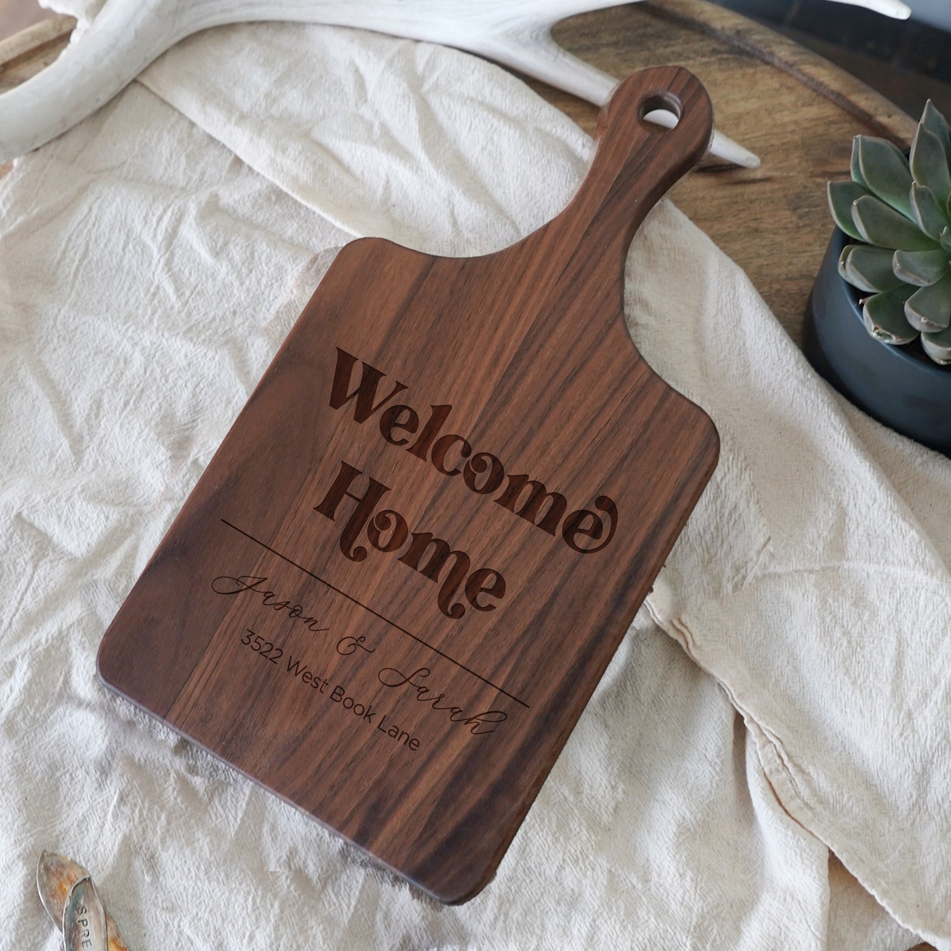 a wooden cutting board sitting on top of a table