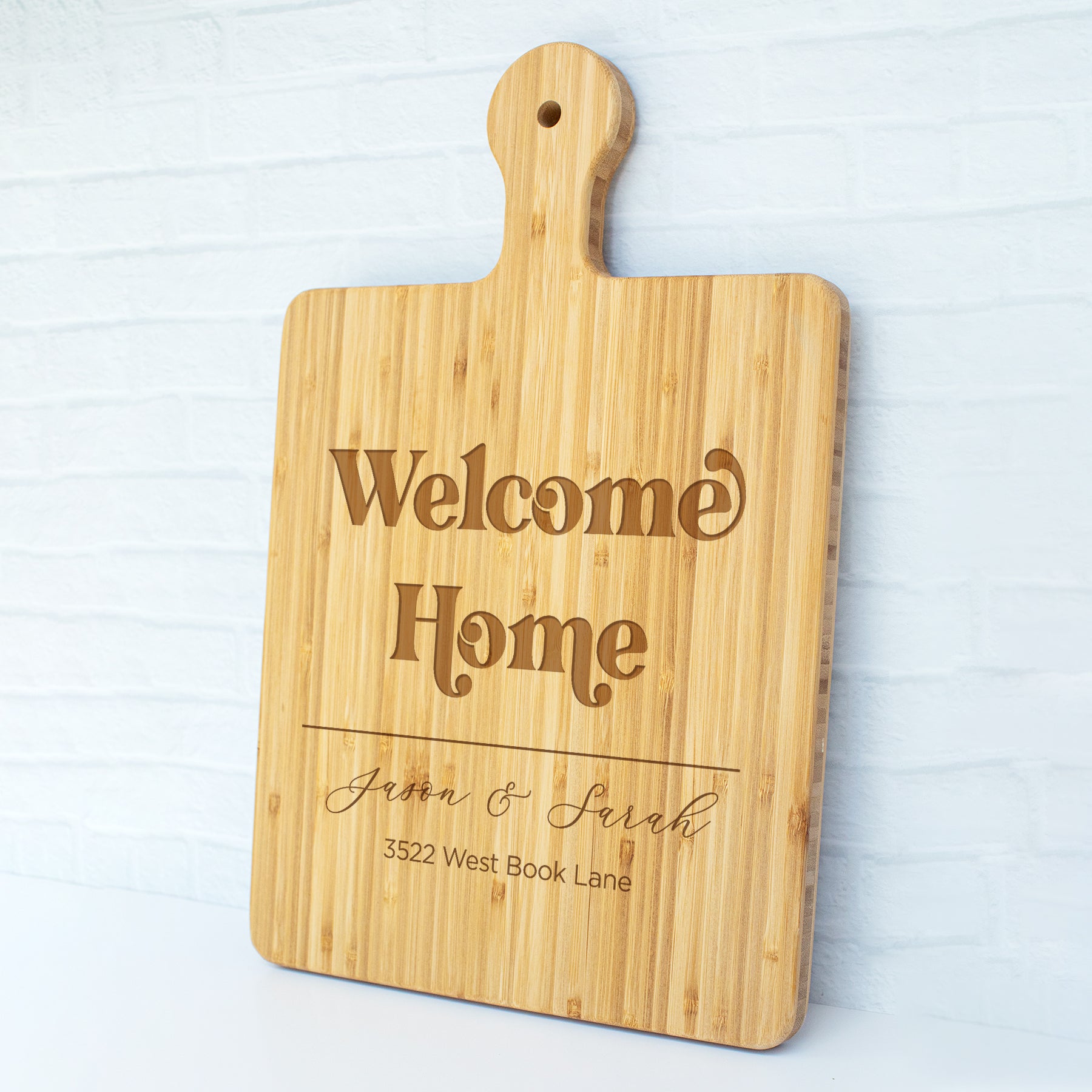 a cutting board with a welcome home sign on it
