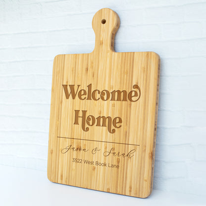 a cutting board with a welcome home sign on it