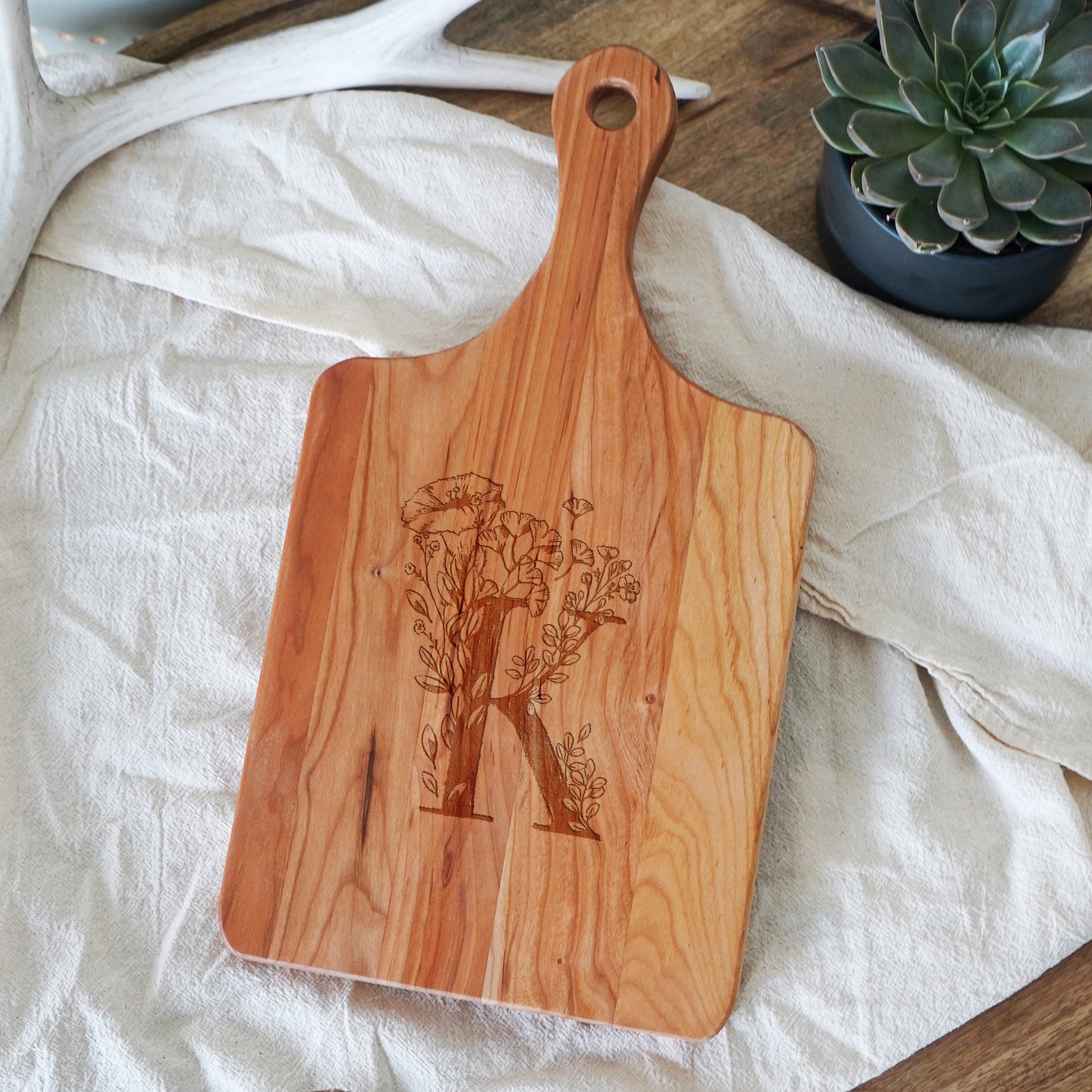 a wooden cutting board sitting on top of a table