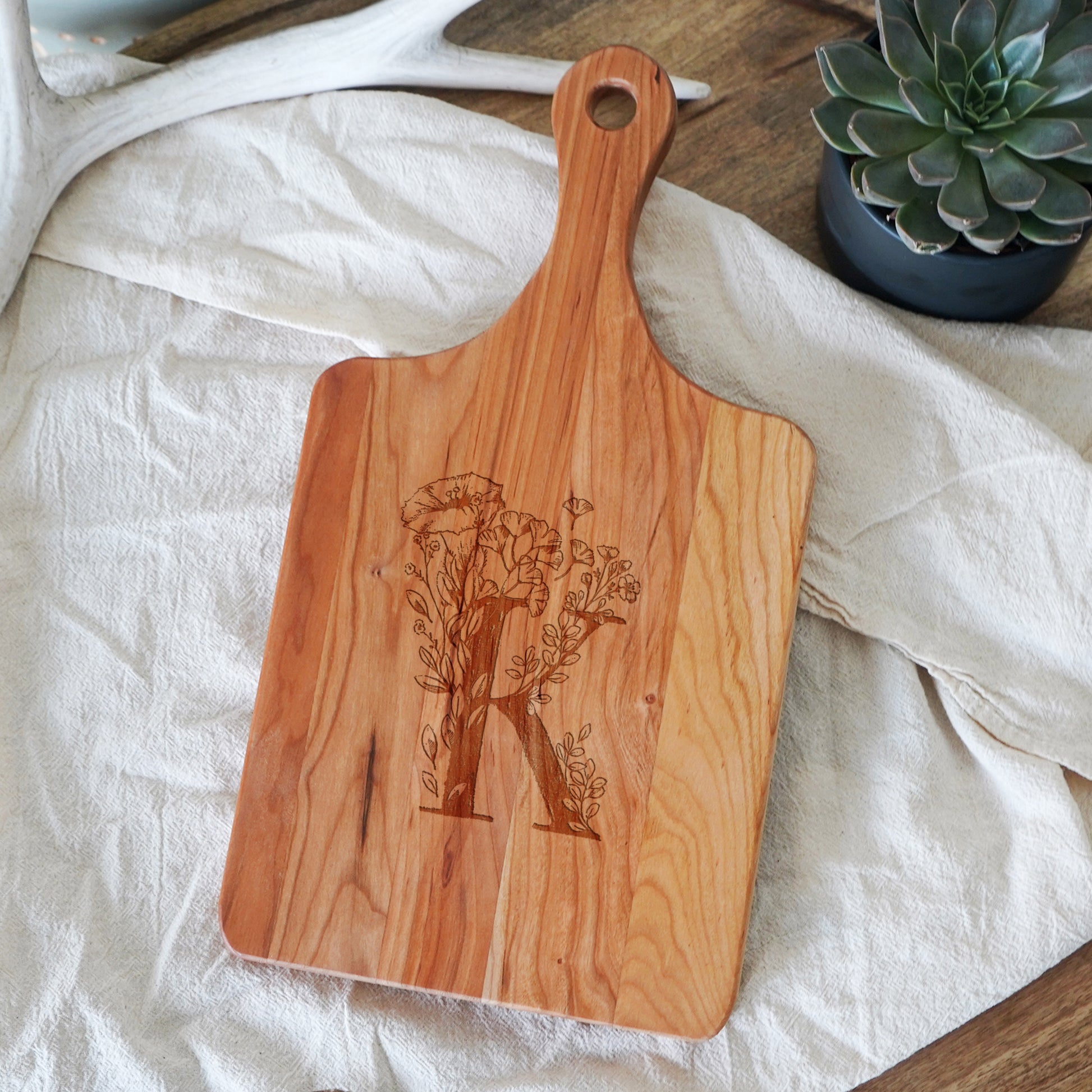a wooden cutting board sitting on top of a table