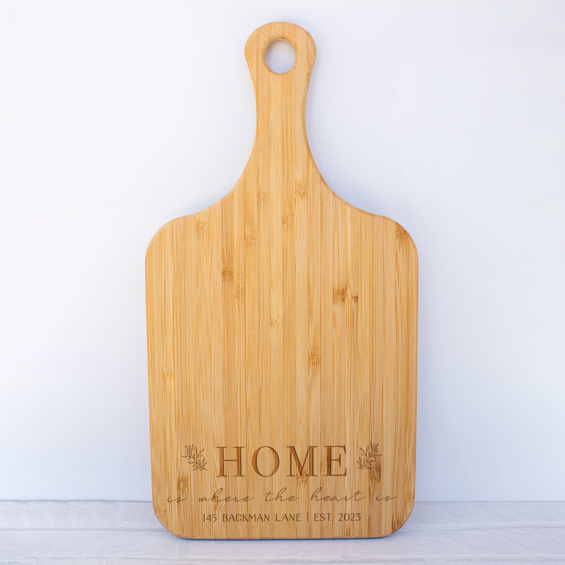 a cutting board with the words home on it