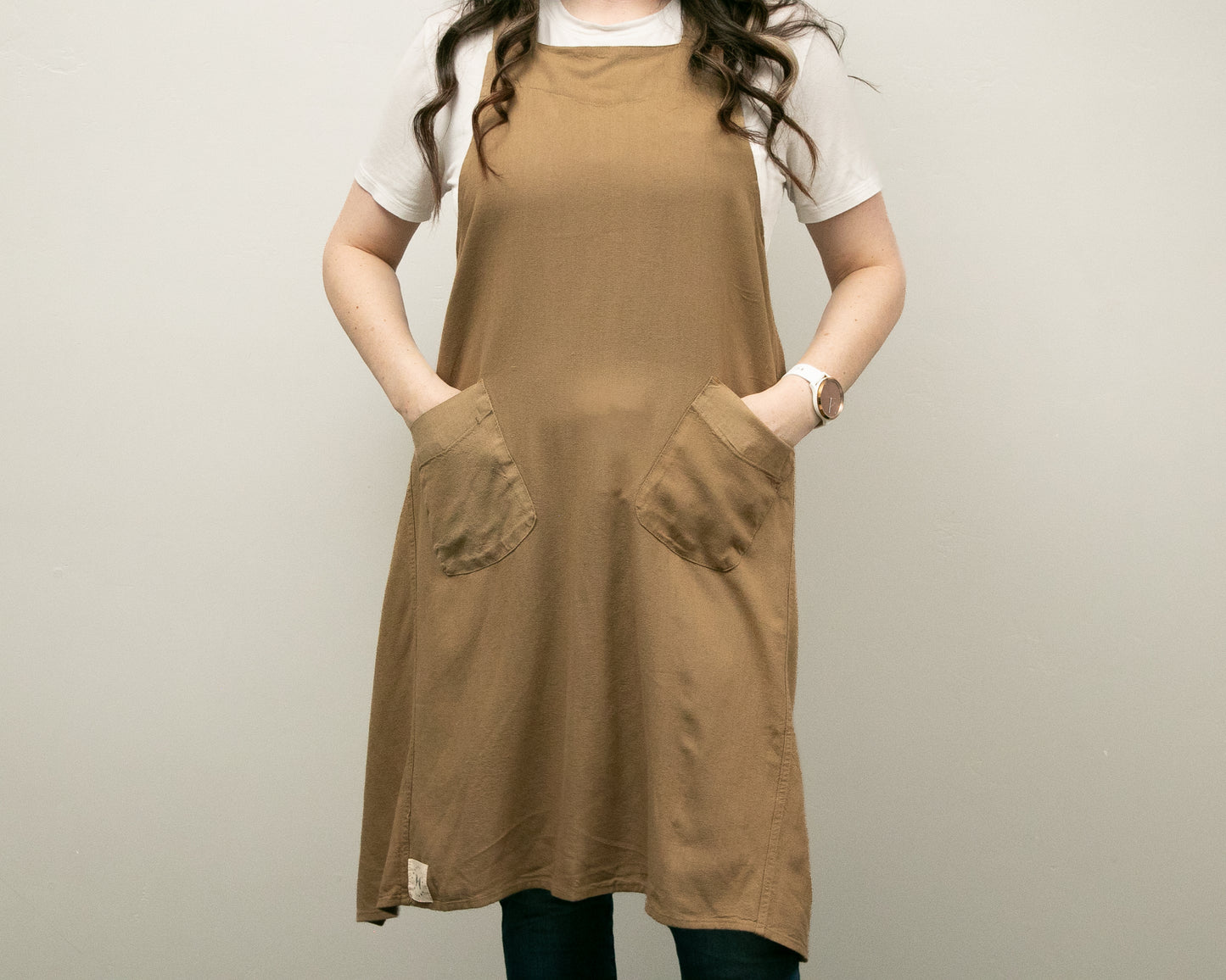 a woman standing with her hands in her pockets