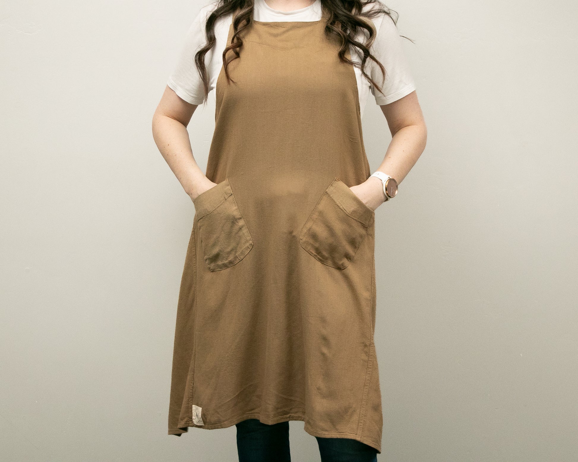 a woman standing with her hands in her pockets