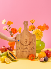 Large Initial Family Name Cutting Board in a colorful floral setting