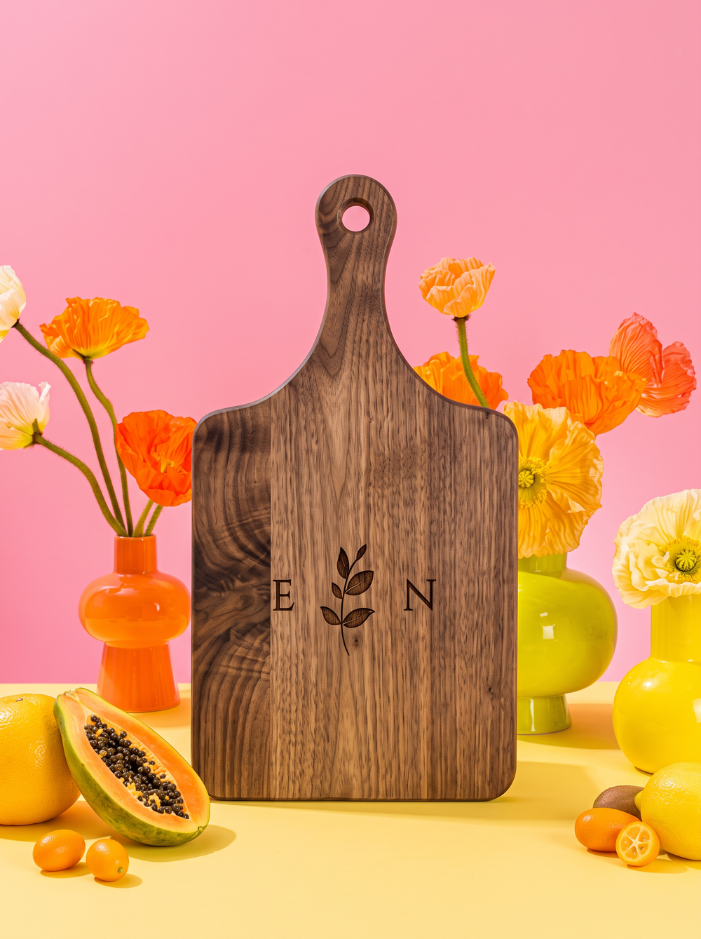 Ivy Initials Cutting Board in a colorful floral setting