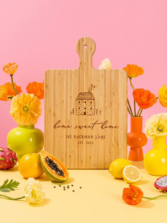 Home Sweet Home Cottage Cutting Board in a colorful floral setting