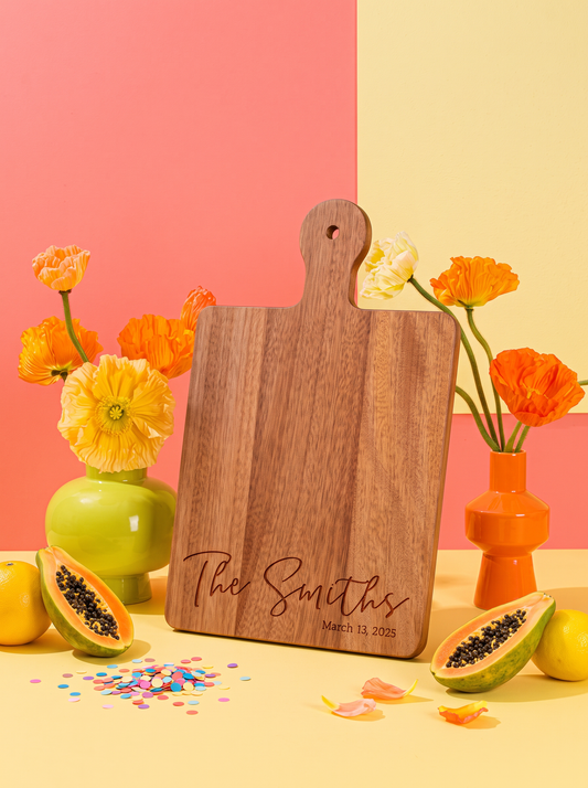 Classic Script Family Name Cutting Board in a colorful floral setting