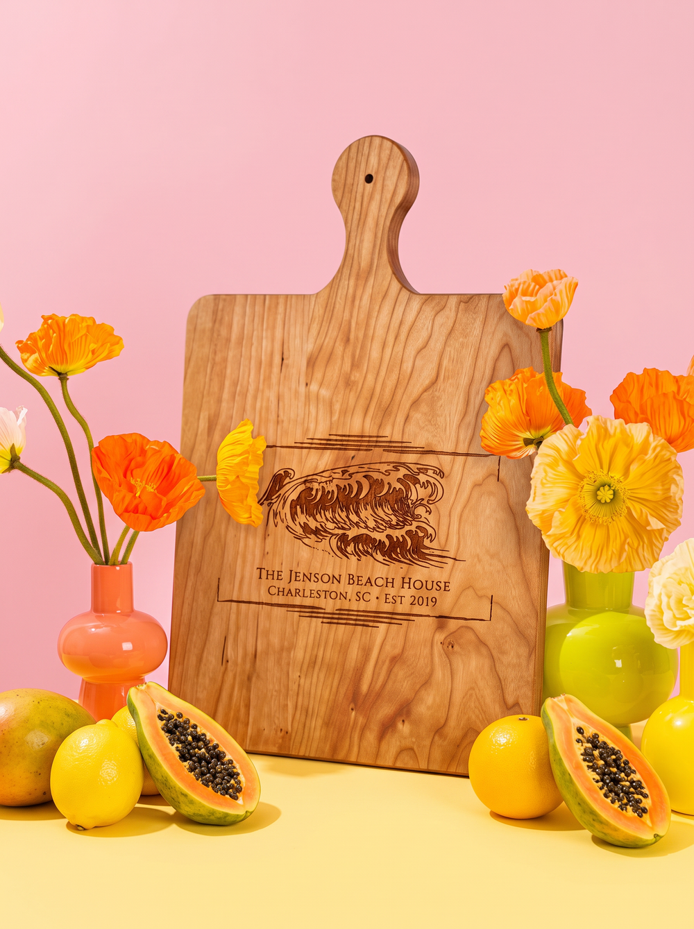 Coastal Wave Name Cutting Board in a colorful floral setting