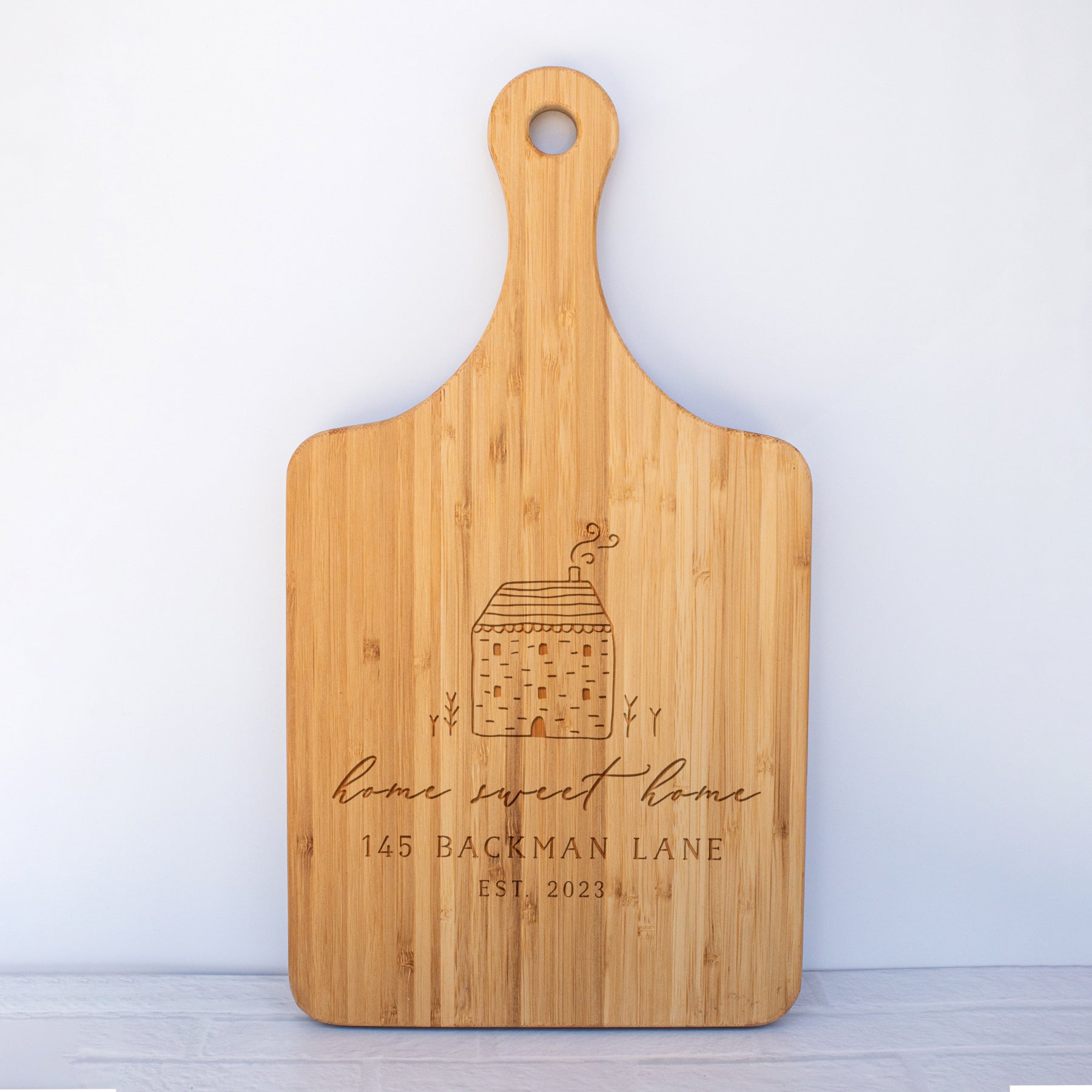a cutting board with a house on it