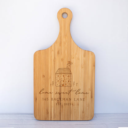 a cutting board with a house on it