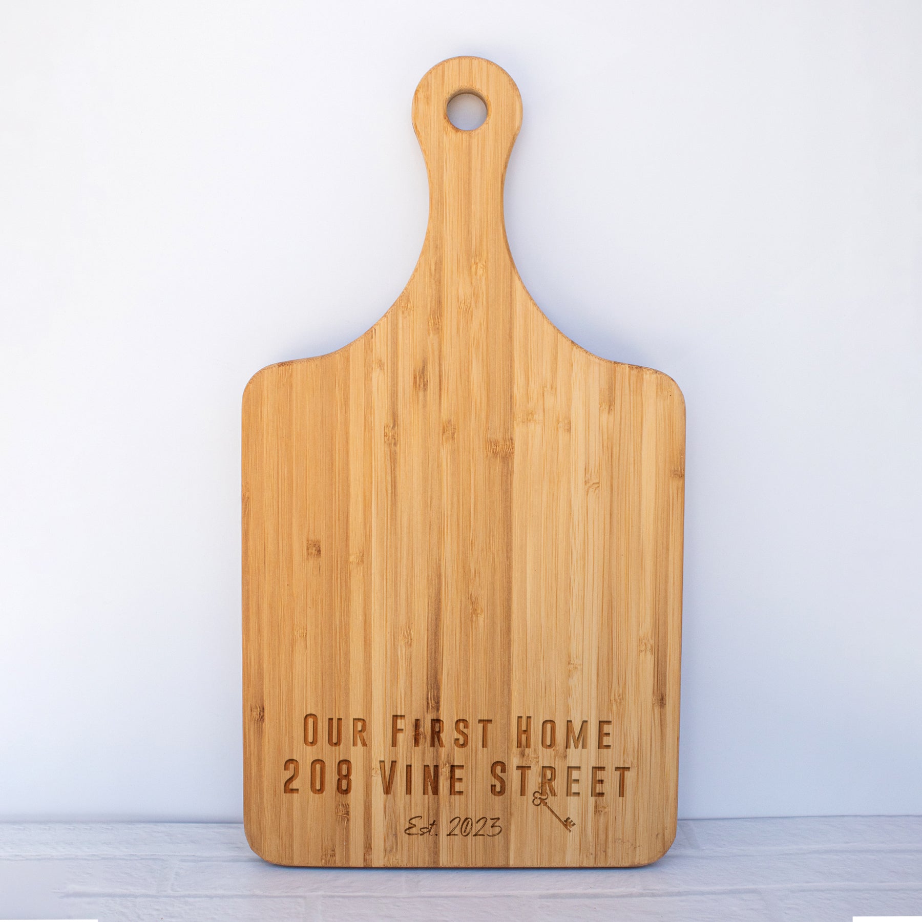 a wooden cutting board with a name on it