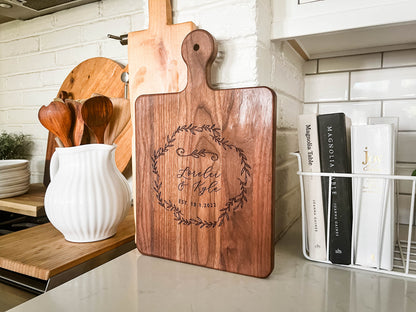 a wooden cutting board sitting on top of a counter