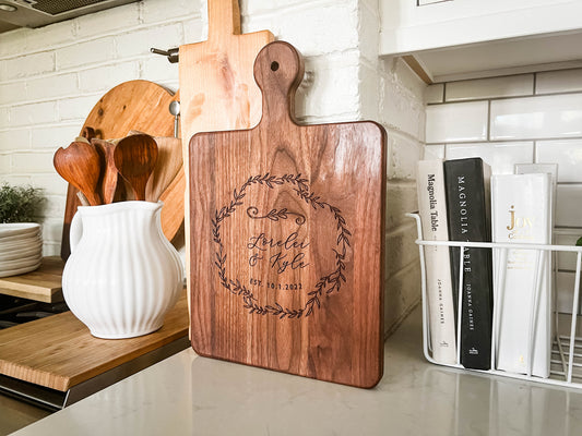 a wooden cutting board sitting on top of a counter