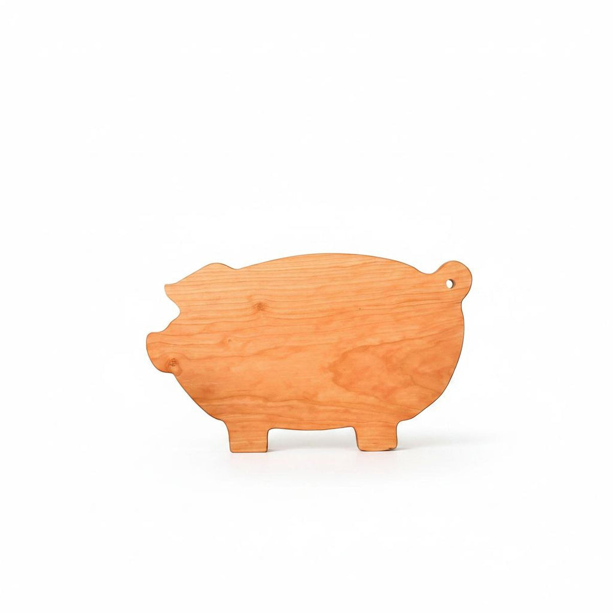 A wooden pig-shaped cutting board is shown against a white background.