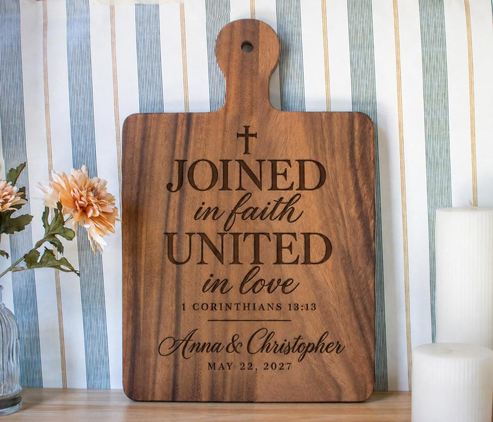 Joined in Faith engraving mockup on a large walnut handled board, with cross, Anna & Christopher and May 22, 2027.