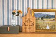 Pumpkin wheat Thanksgiving engraving mockup on a handled bamboo board beside framed art, with BENNETTS and 2026.