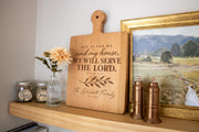 Simulated Serve the Lord engraving on a cherry paddle board beside flowers and framed art, with The Bennett Family and Est. 2026.
