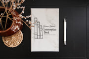 Edited mockup of a white journal with gray marble pattern on a dark table, beside a white pen and dried flowers, with the personalized Commonplace Book cover design.
