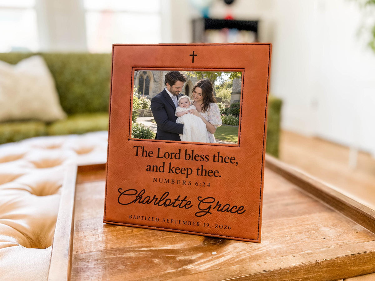 Edited mockup of the charlotte grace baptism frame on a tray, showing a cross above an illustrative family photograph and the blessing, Charlotte Grace and baptism date below.