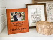 Edited mockup of the charlotte grace baptism frame beside a woven basket and framed drawings, with an illustrative family photograph, cross, blessing, sample name and date.