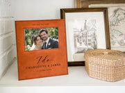 I Do wedding frame mockup on a shelf beside a woven basket and framed art, with an illustrative couple photo and the sample names Charlotte & James and date 14 June 2026.