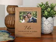 I Do wedding frame mockup beside a lamp and a potted plant, with an illustrative couple photo and the sample names Charlotte & James and date 14 June 2026.