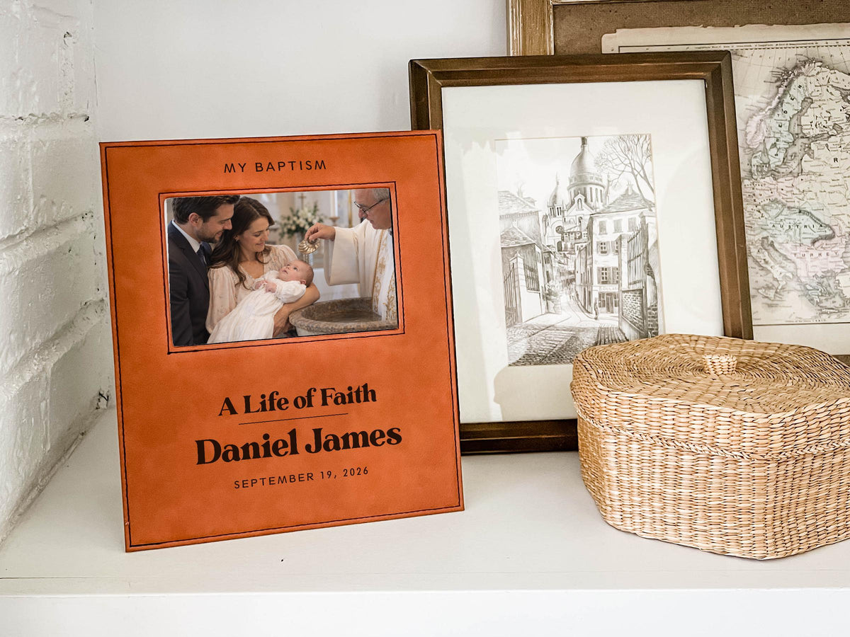 Edited mockup of the life of faith baptism frame on a shelf beside a basket, personalized for Daniel James with September 19, 2026 and an illustrative baby baptism photo.