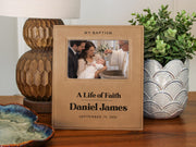 Edited mockup of the life of faith baptism frame beside a lamp and plant, with Daniel James, September 19, 2026 and an illustrative baby baptism photo.