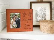 Edited mockup of a brown-toned Together frame on a shelf, with an illustrative wedding portrait at left and paired doves, Charlotte & James, and June 14, 2026 at right.