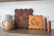 Two scalloped boards in contrasting wood tones showing Grateful Table and Bennett family engraving mockups; board options shown separately.