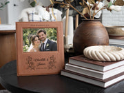 Wedding Roses frame mockup with a sample wedding photo, OUR WEDDING DAY, roses, Charlotte & James and June 14, 2026, beside stacked books and a vase.