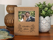Wedding Roses frame mockup with a sample wedding photo, OUR WEDDING DAY, roses, Charlotte & James and June 14, 2026, beside a lamp and leafy plant.