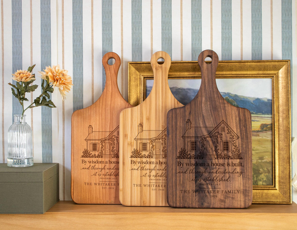 Edited mockup of three handled boards showing Proverbs Garden House engraving on different wood tones.