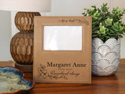 Edited a life so loved memorial frame mockup with songbird and floral engraving, Margaret Anne and 1939-2025; empty photo opening for Gift Options: None.