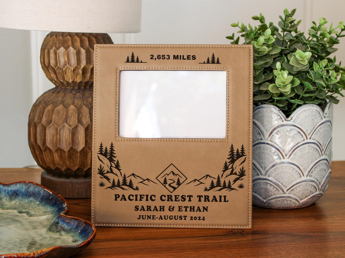 Edited mockup of the Pacific Crest Trail frame with engraved sample text and an empty photo opening, showing the Gift Options choice None.
