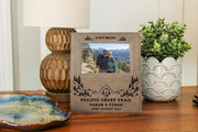 Edited mockup of the Pacific Crest Trail frame between a lamp and plant, with personalized trail text and an illustrative hiking couple photo.