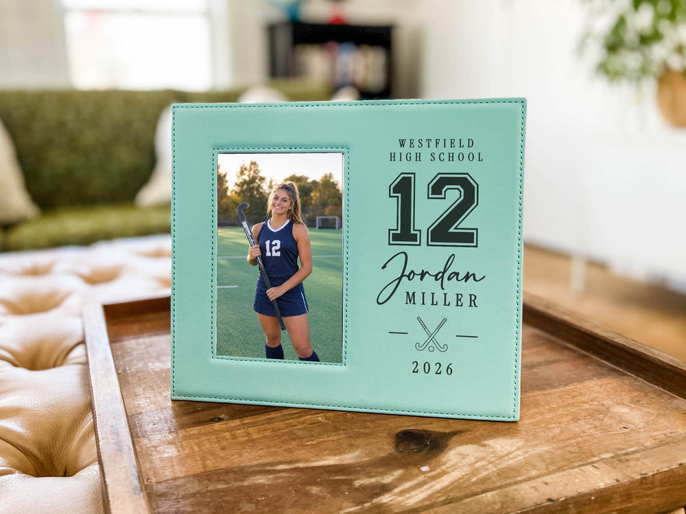 Teal Varsity Field Hockey frame on a wooden tray, with an illustrative player portrait on the left and Westfield High School, number 12, Jordan Miller, crossed sticks and 2026 on the right.