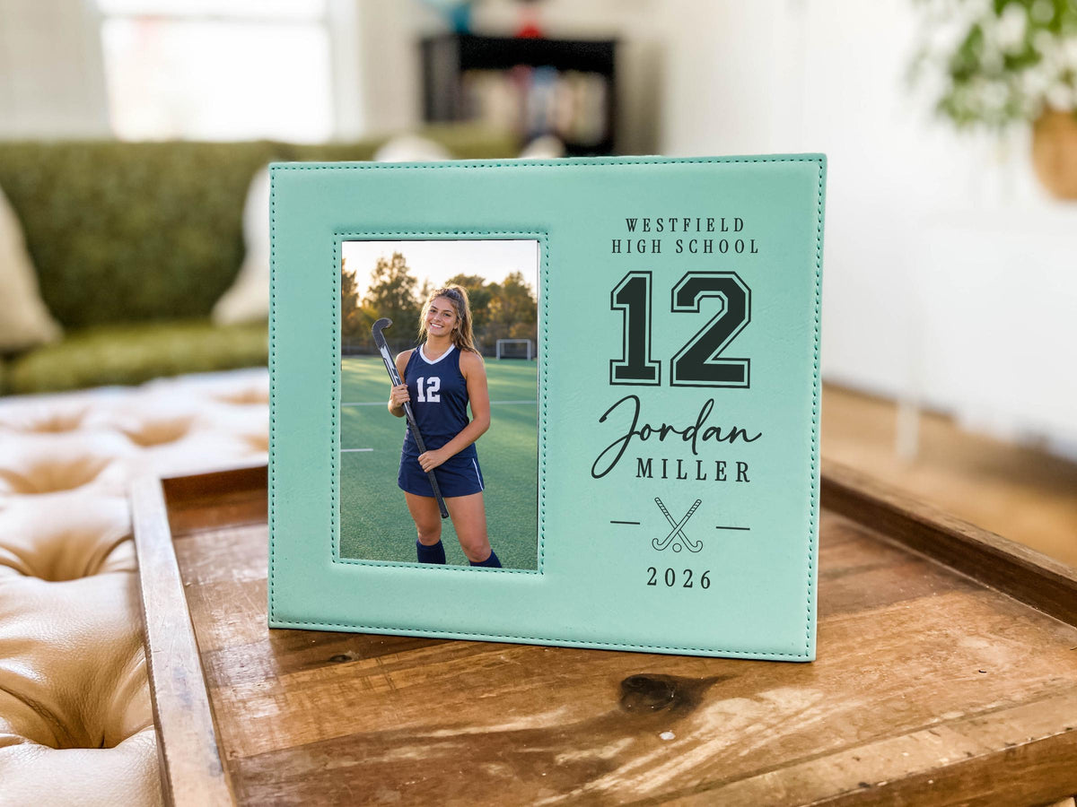 Teal Varsity Field Hockey frame on a wooden tray, with an illustrative player portrait on the left and Westfield High School, number 12, Jordan Miller, crossed sticks and 2026 on the right.