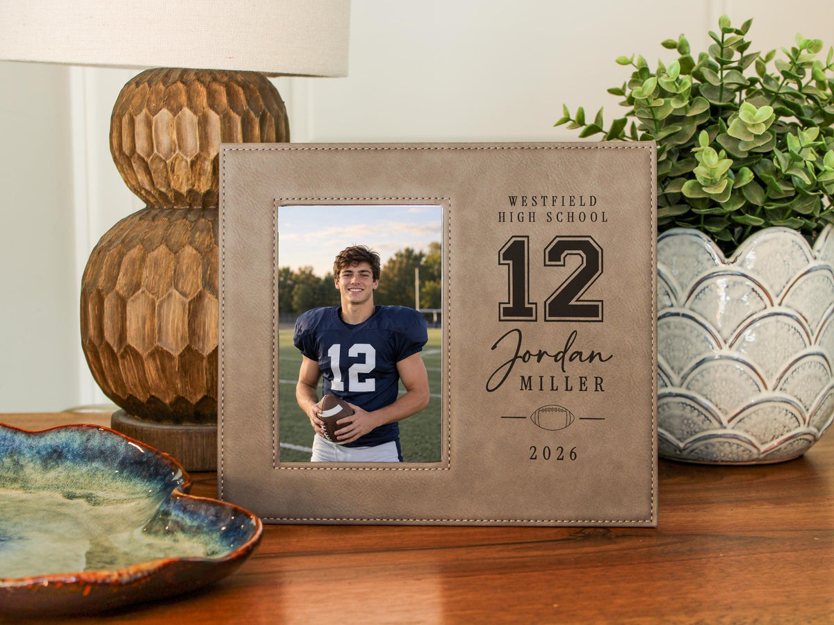 Varsity Football frame mockup beside a lamp, with a portrait football player photo and sample Westfield High School, number 12, Jordan Miller, and 2026 engraving.